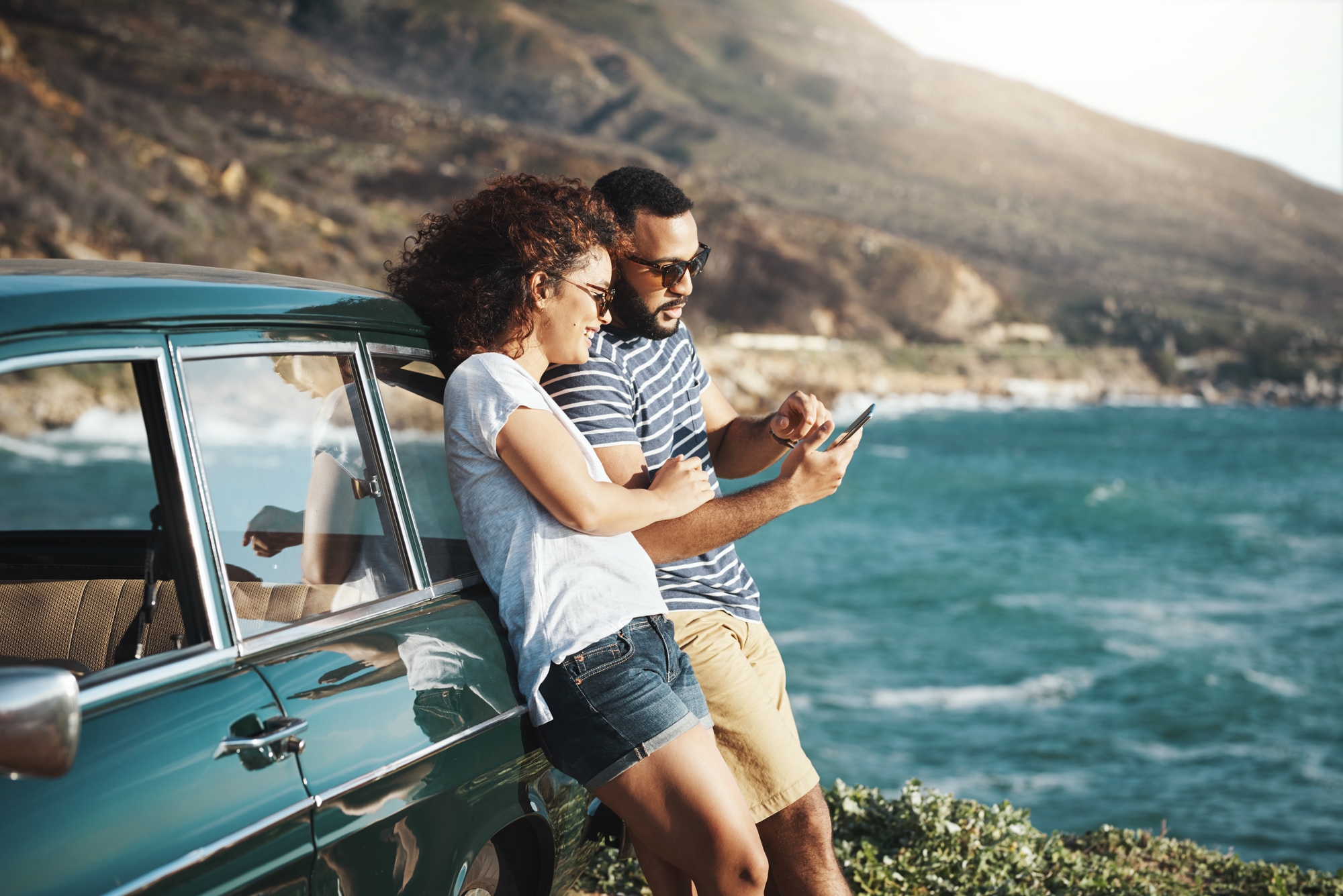 A couple near the beach looking at phone