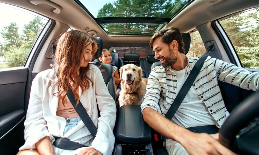 Family driving in a car protected by extended car warranty